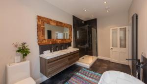 a bathroom with a sink and a shower and a toilet at The Clarence in Bishop Auckland +50 photos