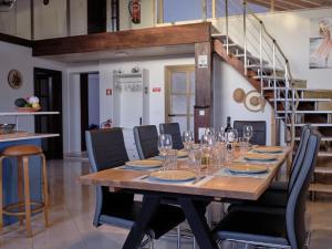 a dining room with a table with chairs and a staircase at Casa Da Liberdade in Alte