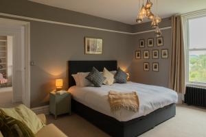 a bedroom with a large bed and a window at The Clarence in Bishop Auckland