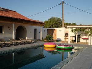 a swimming pool with several colorful inflatable boats in it at Casa Da Liberdade in Alte