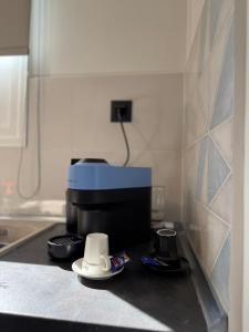 a kitchen with a coffee maker on a counter at Urban Nest Corinth in Korinthos