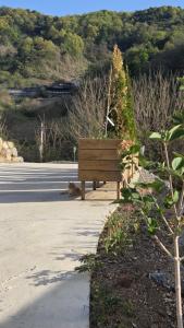 a wooden bench sitting on the side of a road at 산골민박수페쉼 in Jecheon