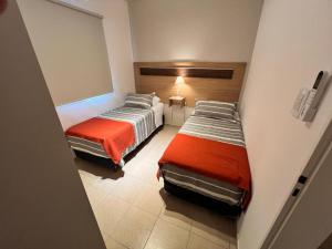 a room with two beds and a window at Alojamiento Guemes II in San Fernando del Valle de Catamarca