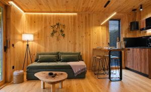 a living room with a couch and a table at Cabanas do Navia in Coea