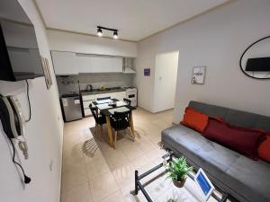 a kitchen and a living room with a couch and a table at Alojamiento Guemes II in San Fernando del Valle de Catamarca