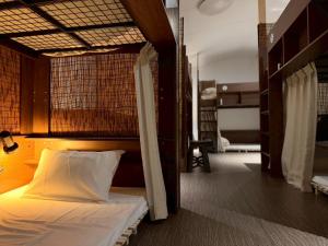 a bedroom with a bed in a room at ura San Jose in Okayama