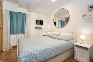 a bedroom with a bed and a mirror at La Pedica B&B in Grottaferrata