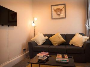 a living room with a couch and a table at Buckie Central 2 bed Retreat 24 high street in Buckie