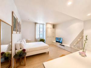 a white bedroom with a bed and a staircase at Èrsextius ABB Aix-en-Provence in Aix-en-Provence
