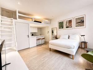 a white bedroom with a bed and a ladder at Èrsextius ABB Aix-en-Provence in Aix-en-Provence +13 photos