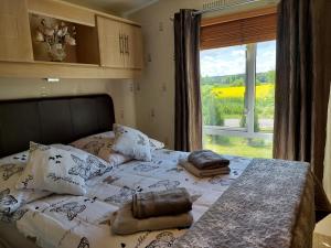 a bedroom with a bed and a window with a view at Agroturystyka Bobrowa Chata in Iława