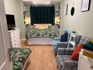 a small room with a bed and a couch and a tv at Lovely Comfortable Available in Hereford in Hereford