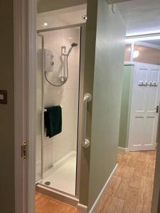 a shower with a glass door in a bathroom at Lovely Comfortable Available in Hereford in Hereford