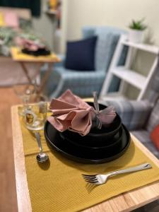 a black plate with a pink bow on it on a table at Lovely Comfortable Available in Hereford in Hereford