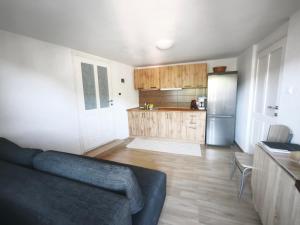 a living room with a couch and a kitchen at Under Rock Guesthouse in Bled