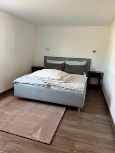 a bed in a room with two tables and a mattress at Ferienhaus Luunsche Landpause in Lunow