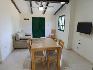 a dining room with a table and chairs and a couch at Finca Magdalena Casa de Campo in San Rafael