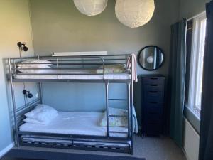 a room with two bunk beds and a mirror at Tängerdalens camping och café in Övertänger +5 photos