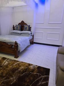 a bedroom with a bed and a couch at Bwera-Comfortable Homes in Kasese