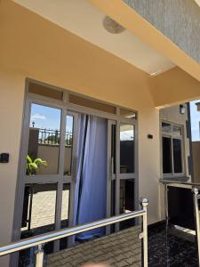 a balcony with sliding glass doors in a house at Bwera-Comfortable Homes in Kasese