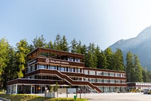 a building with a staircase in front of a mountain at Nordic Hostel in Lenz