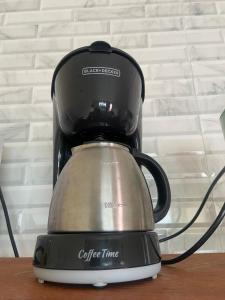 a black and silver coffee timer sitting on a table at Apartamento 2 Vargem Grande RJ in Rio de Janeiro