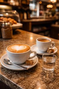 two cups of coffee sitting on top of a counter at Diecizero Affittacamere in Barùmini