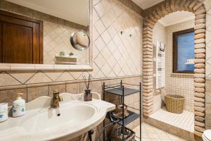 a bathroom with a sink and a shower at La Pedica B&B in Grottaferrata