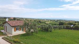 a small white house in a field with trees at Sea View Villa, 4-6 Guests in Cupra Marittima