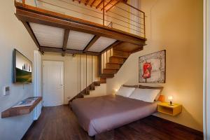 a bedroom with a large bed and a staircase at Chianti B&B Design infinity pool shared in Pianella