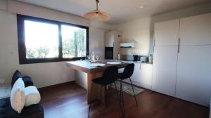 a kitchen with a table and chairs in a room at Ianos Living Spaces - 01 in Korinthos