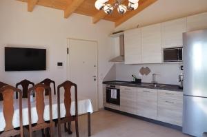 a kitchen with a table and a refrigerator at Sea View Villa, 4-6 Guests in Cupra Marittima