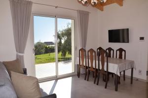 a dining room with a table and chairs and a tv at Sea View Villa, 4-6 Guests in Cupra Marittima