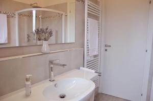a white bathroom with a sink and a mirror at Sea View Villa, 4-6 Guests in Cupra Marittima +64 photos