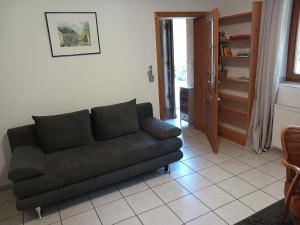 a living room with a couch and a door at Ferienwohnung Blum in Antweiler