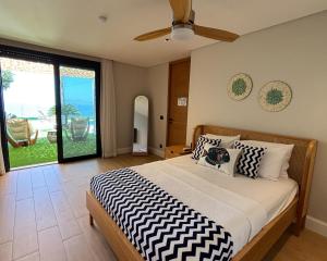 a bedroom with a bed with black and white pillows at Villa Aktürk in Bodrum City +91 photos