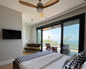 a bedroom with a bed and a view of the ocean at Villa Aktürk in Bodrum City