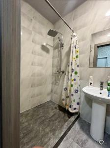 a bathroom with a shower and a sink at Lola Hotel in Yangiyer