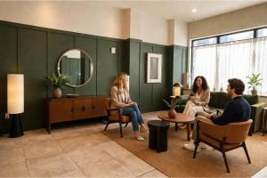 a group of people sitting in chairs in a room at Dutch Hotel Long Island City New York , Belvilla District 6 Formerly Sonder in Long Island City