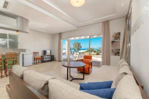 a living room with a couch and a table at Lunja Village - Agadir in Taghazout