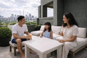 a family sitting around a table on a rooftop at Dutch Hotel Long Island City New York , Belvilla District 6 Formerly Sonder in Long Island City +40 photos
