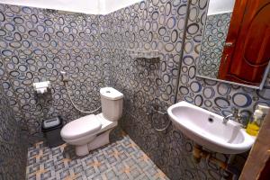 a bathroom with a toilet and a sink at Golo Tango Homestay in Labuan Bajo +45 photos