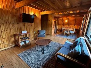 a living room with a couch and a table at Rayen Mahuida - Las Trancas in Las Trancas