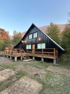 a large black house with a large deck at Rayen Mahuida - Las Trancas in Las Trancas