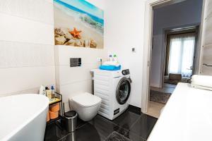 a bathroom with a washing machine and a toilet at Casa DIAMOND LUX&SPA in Sovata +79 photos