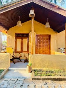 a house with a bench in front of it at TravelLodge Eco in Arugam Bay