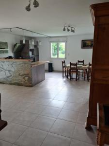 a kitchen and dining room with a table and chairs at La Maison de choupette in Fougerolles