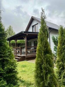 a house with a gazebo and some trees at SOCHÓWKA nad Jeziorem Skarlińskim in Kurzętnik