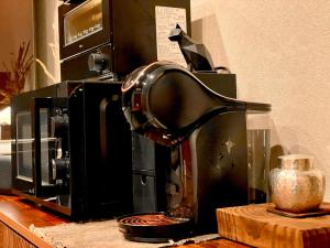 a coffee maker on a counter next to a microwave at 玄Gen Private Villa in Takayama