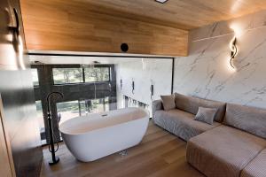a large bath tub in a room with a couch at Green Field Villa in Kuressaare